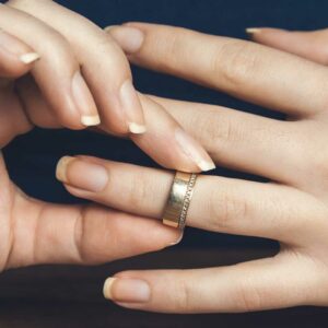 manos de mujer, quitando anillo de bodas de oro, divorcio, derecho de familia de Florida